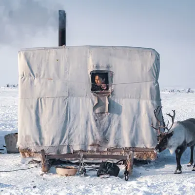 Woman observes tundra in the Russian arctic