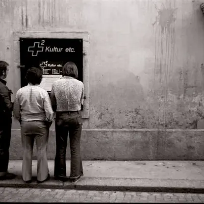 Men Reading a Posted Flyer